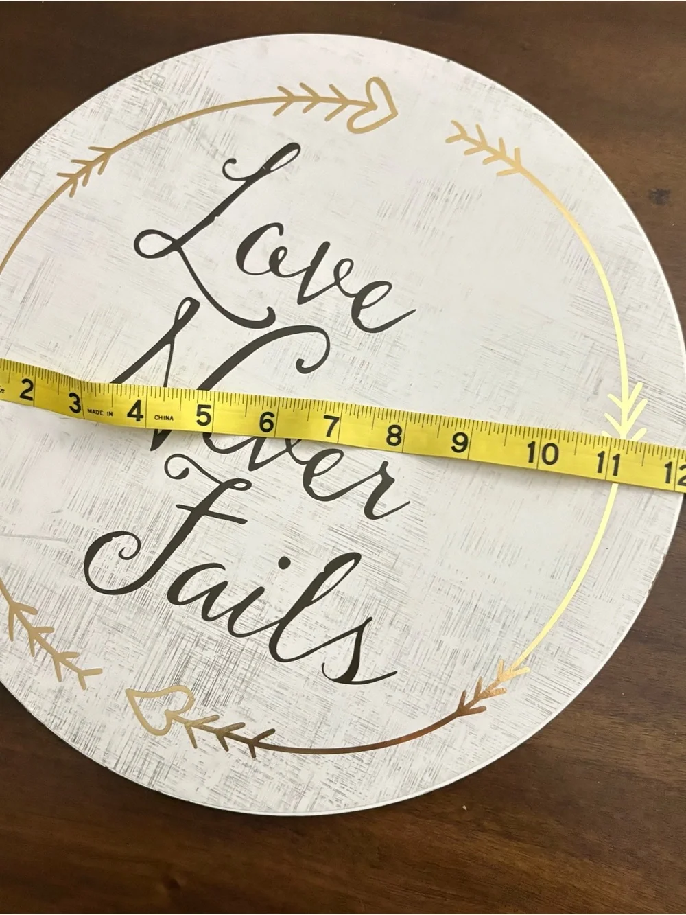 Love Never Fails Round Wall Sign - White with Black Script 12” home decor